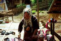© Copyright - Raphael Kessler 2011 - Thailand - Akha tribal woman in full regalia sets out her wares