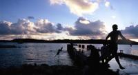 © Copyright - Raphael Kessler 2011 - Tonga - Vava'u - Boys diving from the pier at sunset