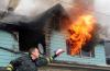 (c) Copyright - Raphael Kessler 2011 - Sweden - Trying to put a house fire to good use with a bag of marshmallows.